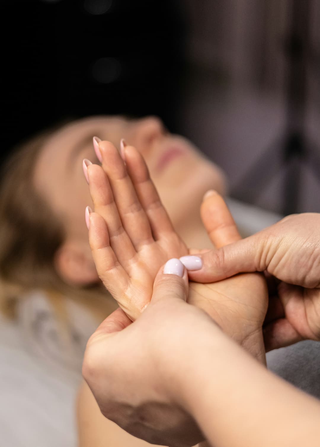 picture of a a woman receiving a hand massage